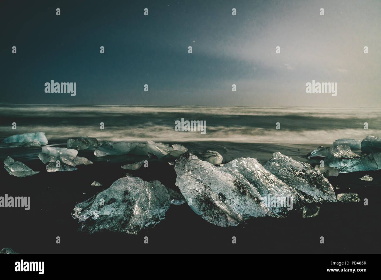 Night stars Ice rock with black sand beach at Jokulsarlon beach (Diamond beach) in southeast Iceland Stock Photo