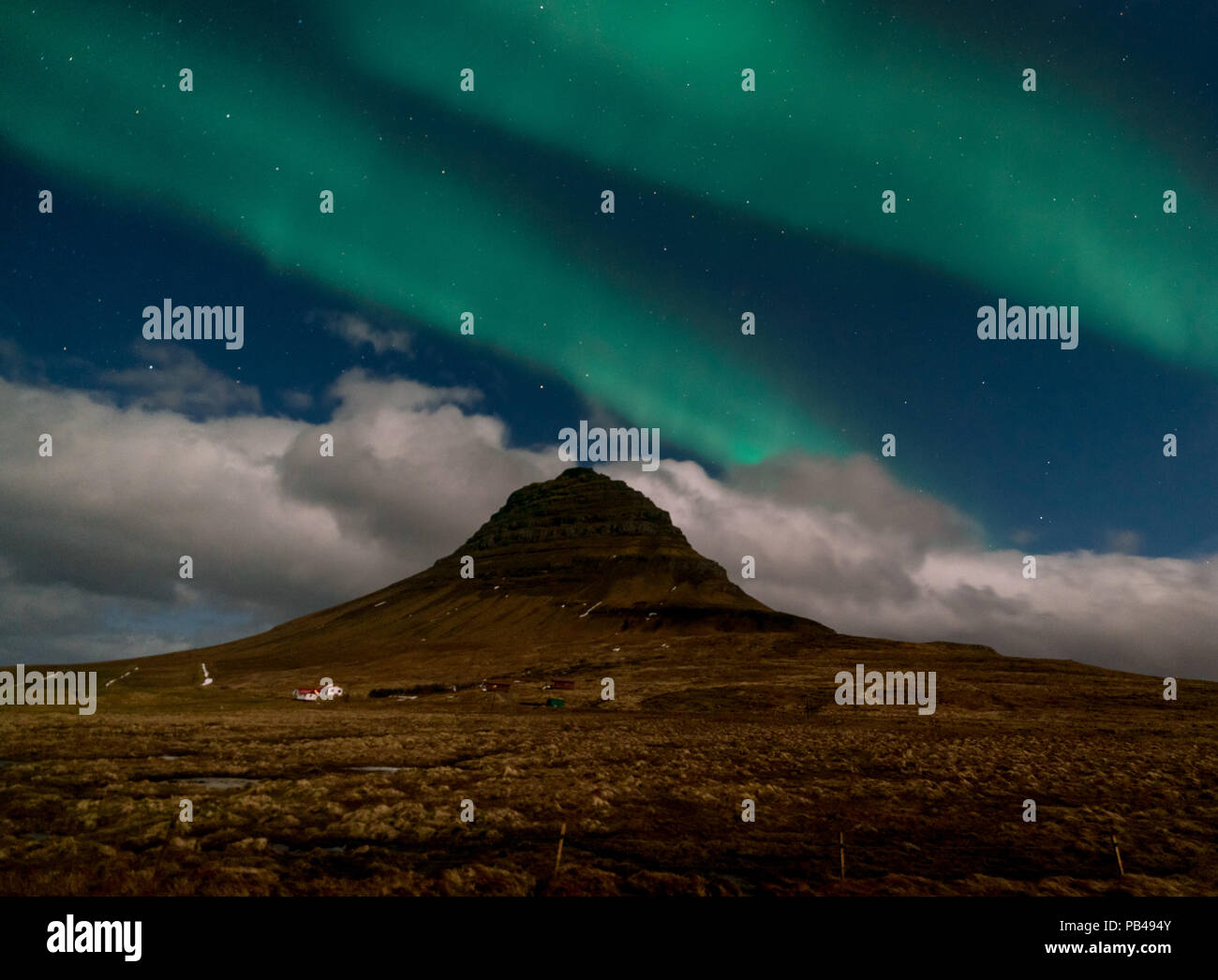 Northern lights aurora borealis appear over Mount Kirkjufell in Iceland