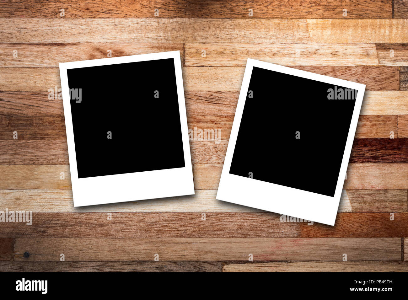Blank photo frames on wood background Stock Photo