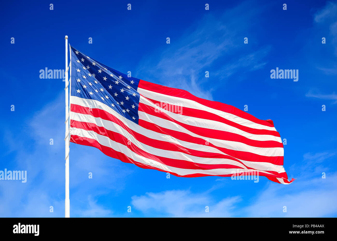 American Flag and Clouds Stock Photo