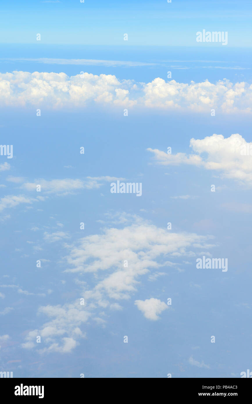 Beautiful view of blue sky above the white clouds from airplane window ...