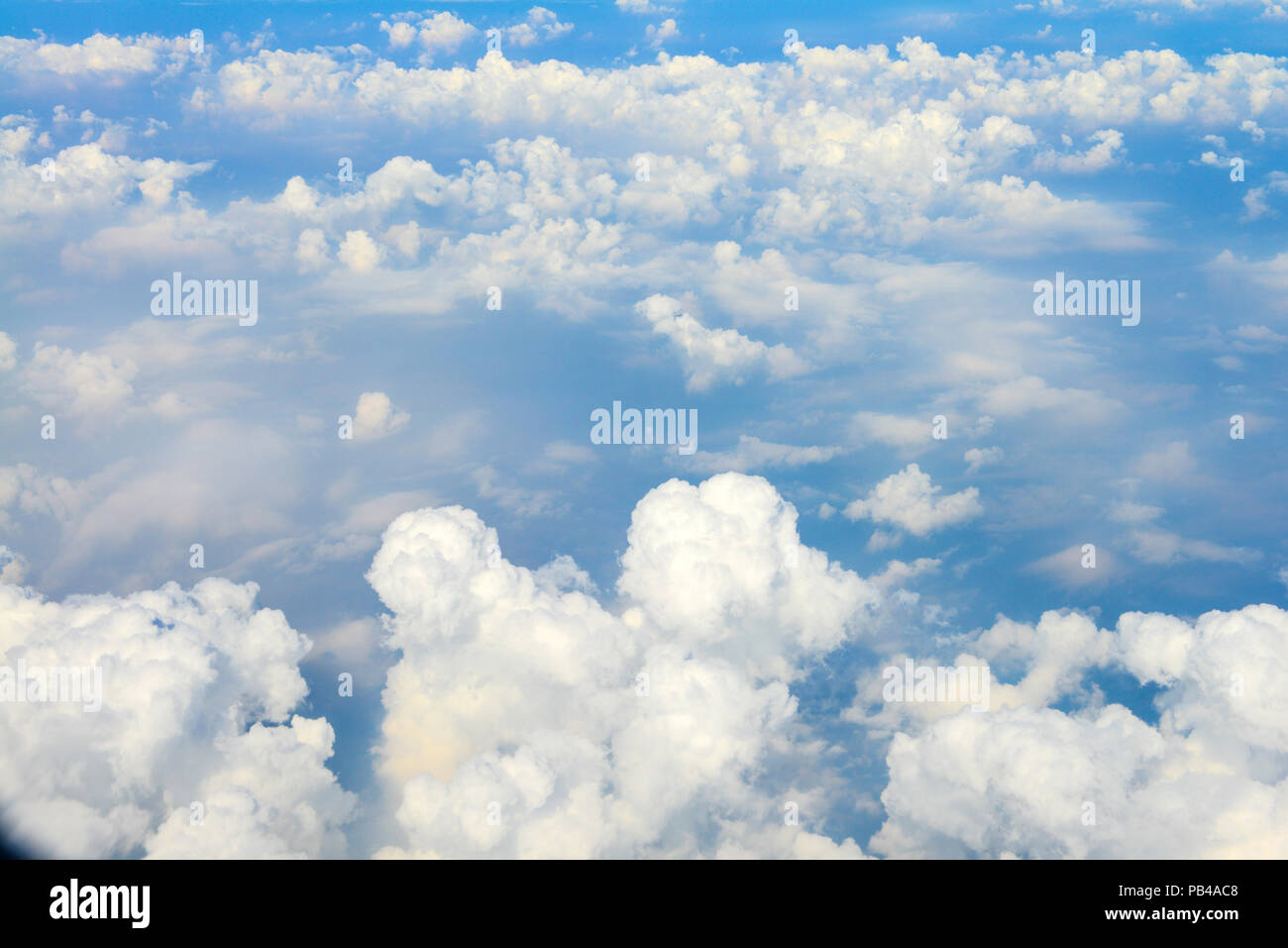 Beautiful view of blue sky above the white clouds from airplane window ...