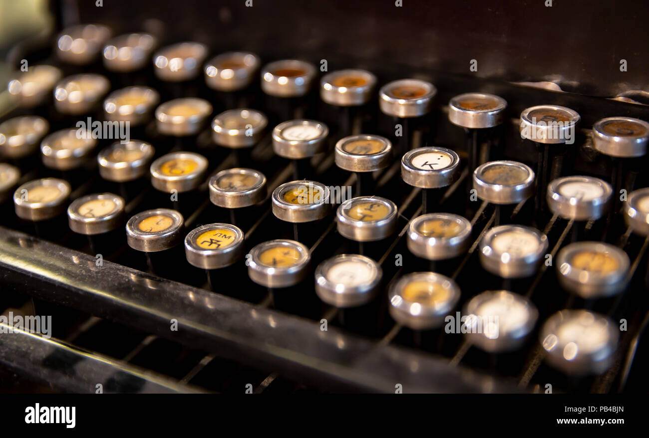 Details of an old fashioned typewriting machine. A typewriter is a mechanical or electromechanical machine for writing characters similar to those pro Stock Photo