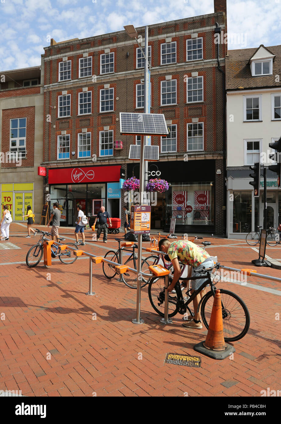 Reading town centre, Berkshire. Pedestrianised section of Broad Street. Shows shoppers, pedestrians and parked bicycles Stock Photo
