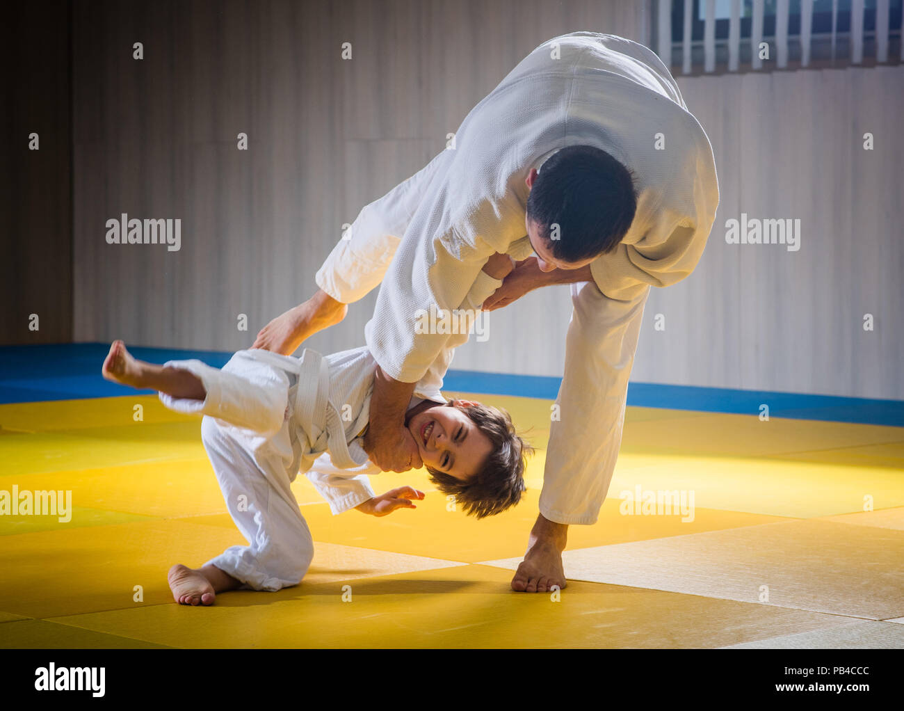 Man and young boy are training judo throwing Stock Photo Alamy