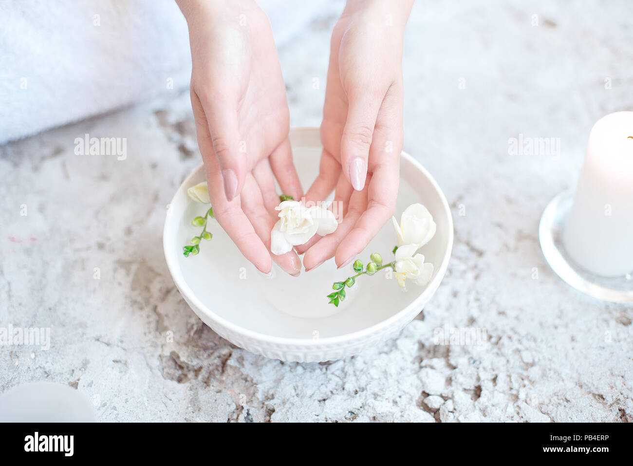 Woman In Beauty Salon Holding Hands In Aroma Bath Before Spa Procedure