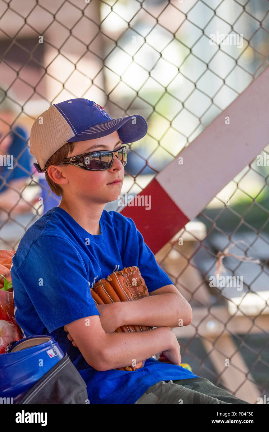 12 Year old boy, holding glove, looking thoughtfull, close up, wearing