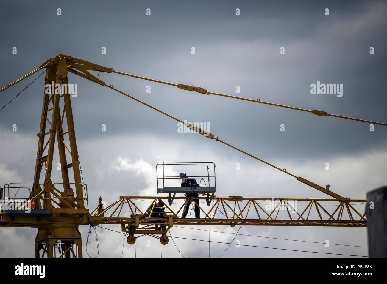 Belgrade, Serbia - Workers repairing a construction crane high above the ground Stock Photo