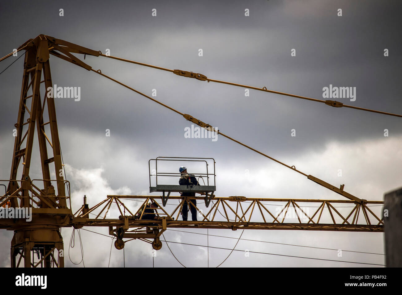 Belgrade, Serbia - Workers repairing a construction crane high above the ground Stock Photo