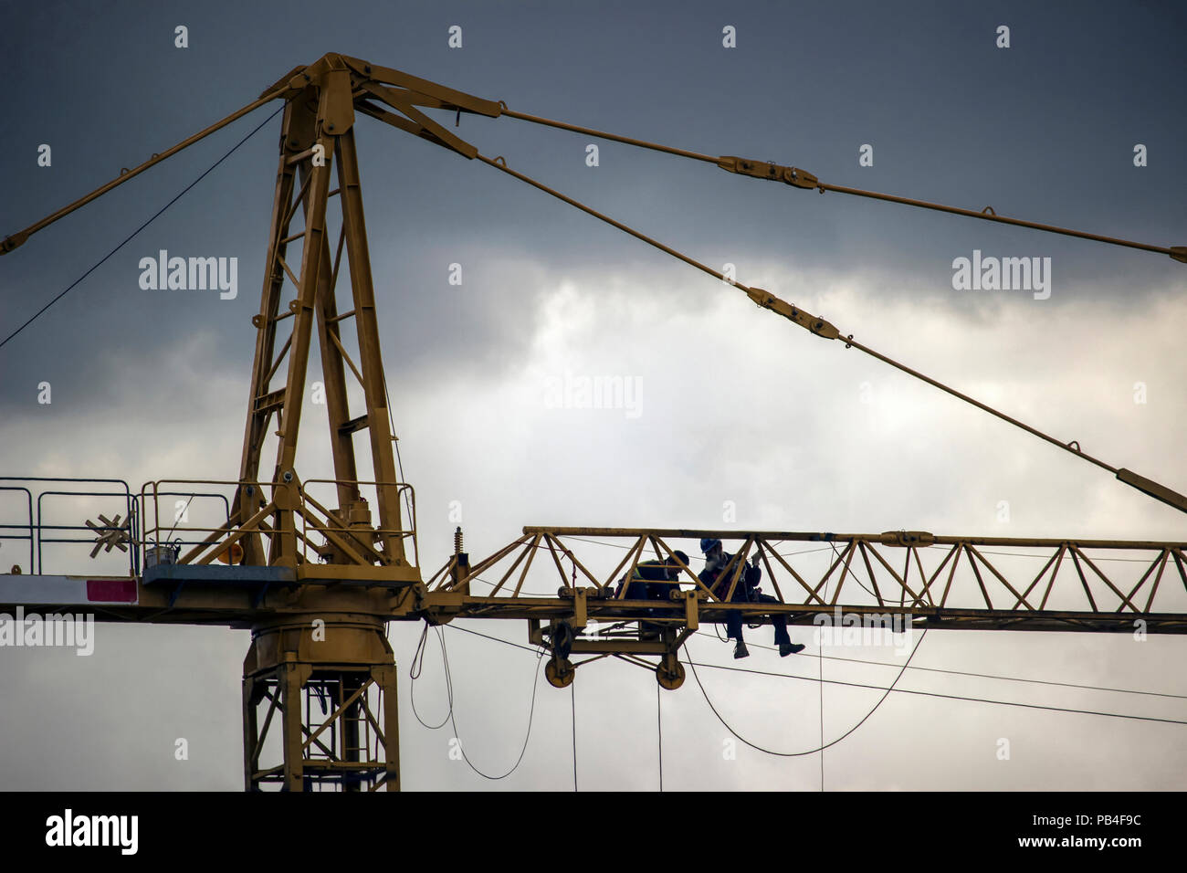 Belgrade, Serbia - Workers repairing a construction crane high above the ground Stock Photo