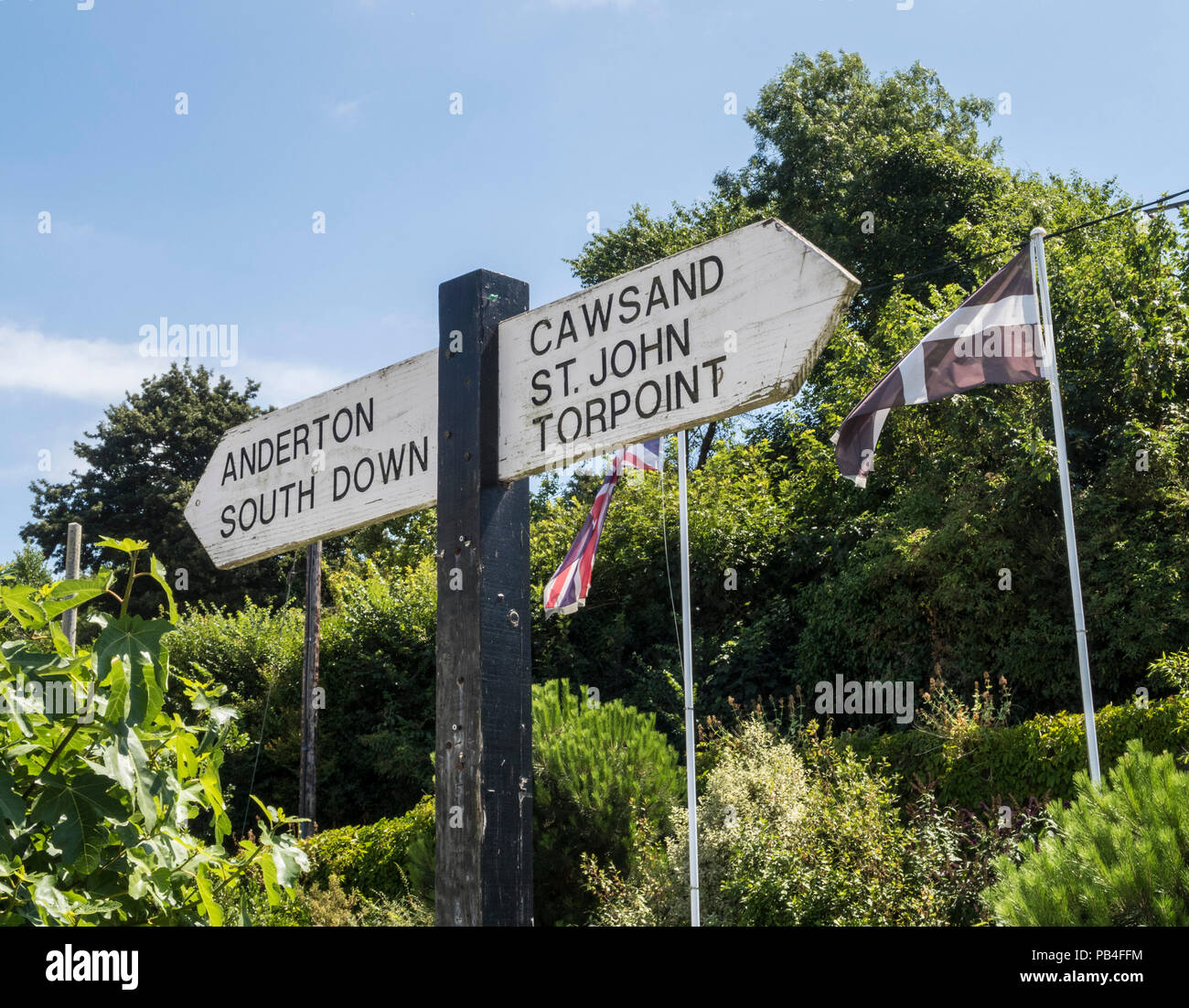 Cornish flag and signpost to Torpoint,Anderton,South Down,Cawsand, and St John at Millbrook, Cornwall Stock Photo