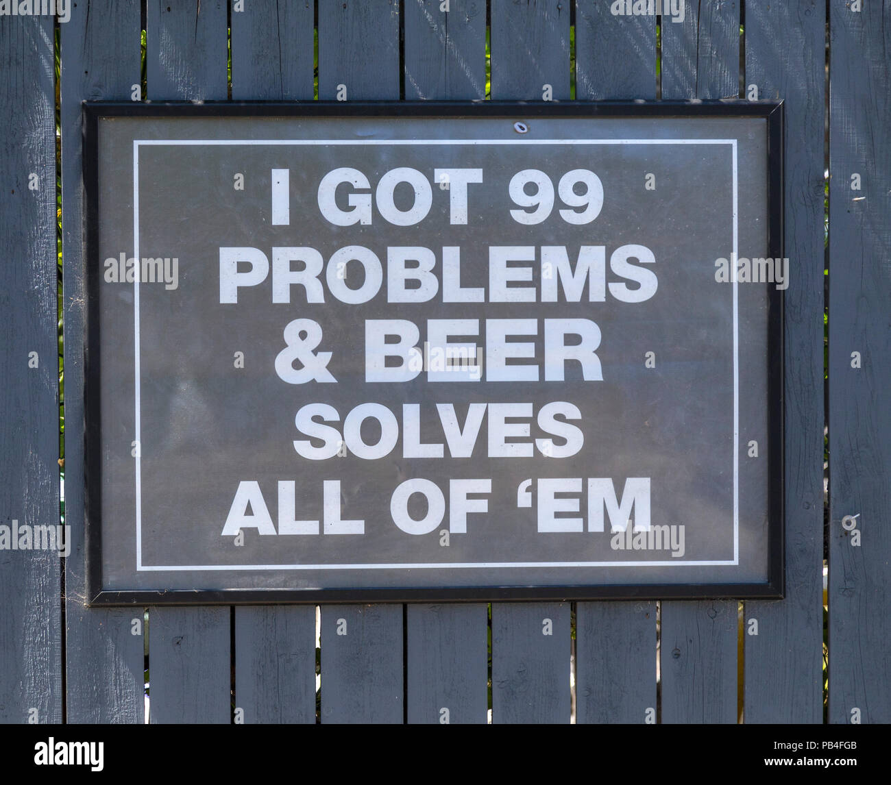 Sign saying - I got 99 problems and beer solves all of them. Outside the Devon & Cornwall pub, Millbrook, Cornwall. Stock Photo