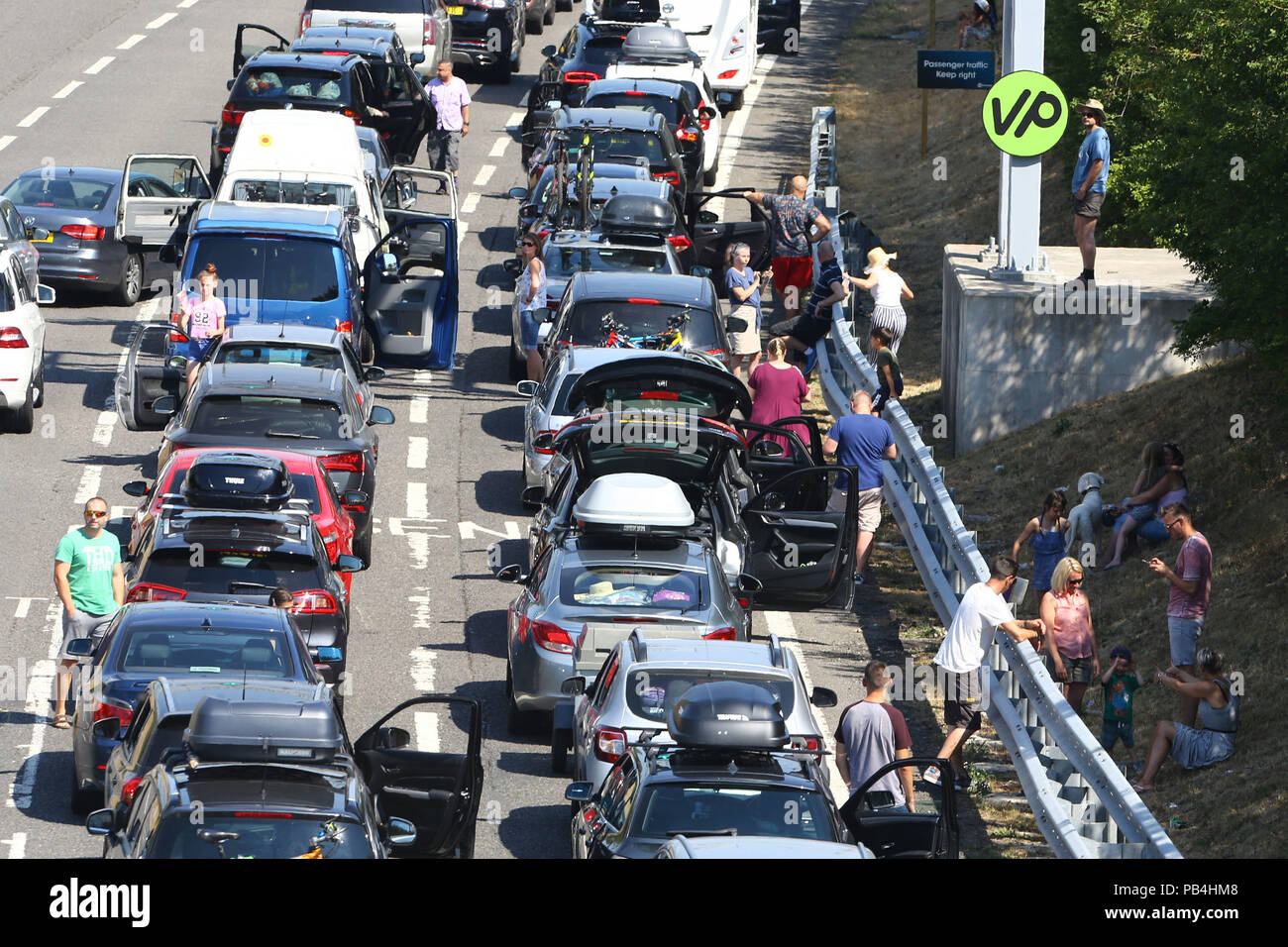 Queues for the Eurotunnel in Folkestone, Kent, stretch back towards the M20 motorway as passengers using the cross-Channel services were warned of delays of up to five hours after air-conditioning units failed on trains amid sizzling temperatures. Stock Photo