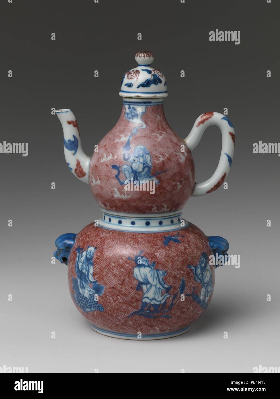 Wine Vessel with Daoist Immortals. Culture: China. Dimensions: H.  (20.3 cm); W. 5 1/8 in. (13 cm); Diam. of foot 3 in. (7.6 cm).  The eight figures belong to a group codified in the twelfth century due to the flowering of Daoist practices at the time. Often based on quasi-historical figures, they are distinguished from one another by the attributes they hold, including the gourds that influenced the shape of this ewer. Museum: Metropolitan Museum of Art, New York, USA. Stock Photo