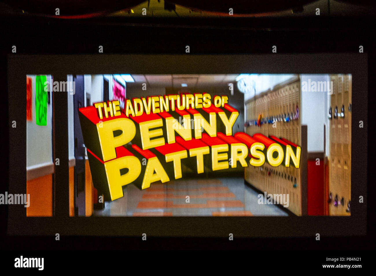 Bellmore, New York, USA. July 18, 2018. Title of comedy sci-fi The Adventures of Penny Patterson, flashes on high school hallway at start of the woman directed film, at LIIFE 2018, the Long Island International Film Expo. The movie, about a high school student facing obstacles to winning science fair when her boyfriend suddenly becomes a superhero, was nominated at LIIFE for Best Student Film, and is screening July 21 at the San Diego Comic-Con International Independent Film Festival, CCI-IFF 2018. Stock Photo