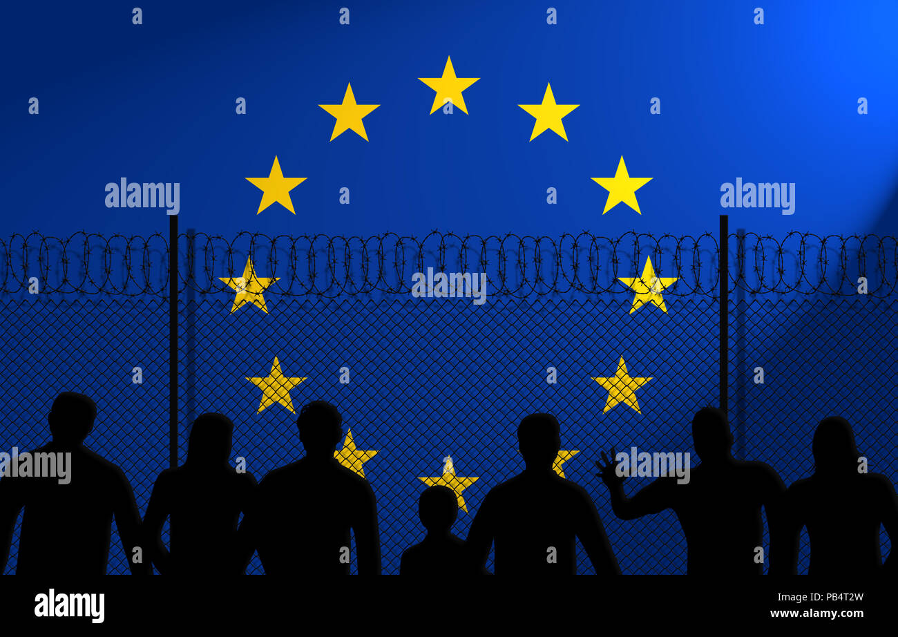 People in front of a secured fence. European Union flag behind. Stock Photo