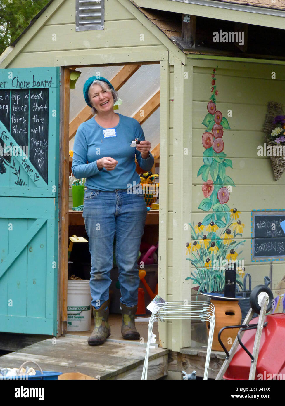 Woman smiling at the door of garden shed, Yarmouth ME Stock Photo