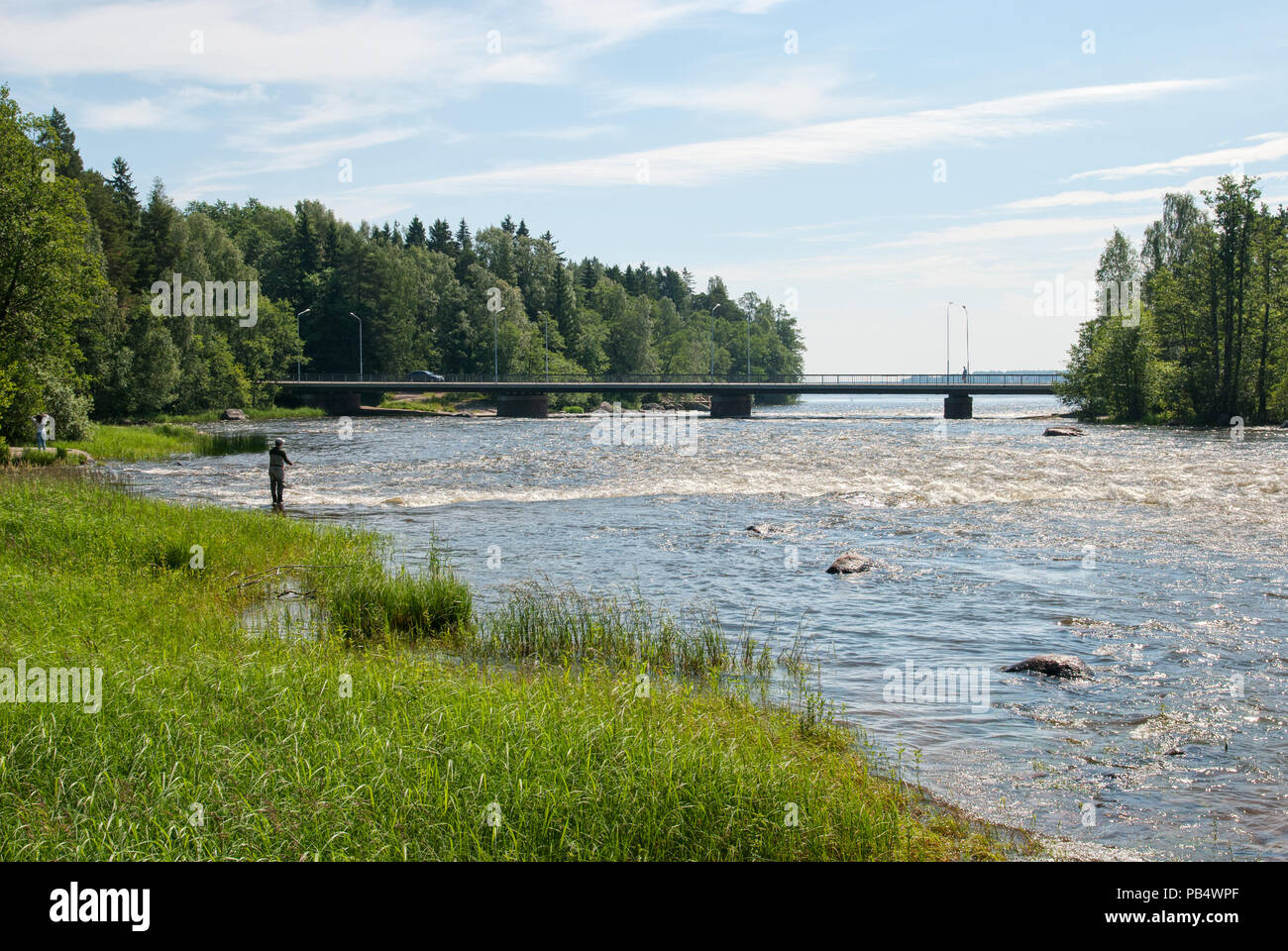 Kotka. Finland. Fisherman near Langinkoski Rapid on Kymi River Stock Photo