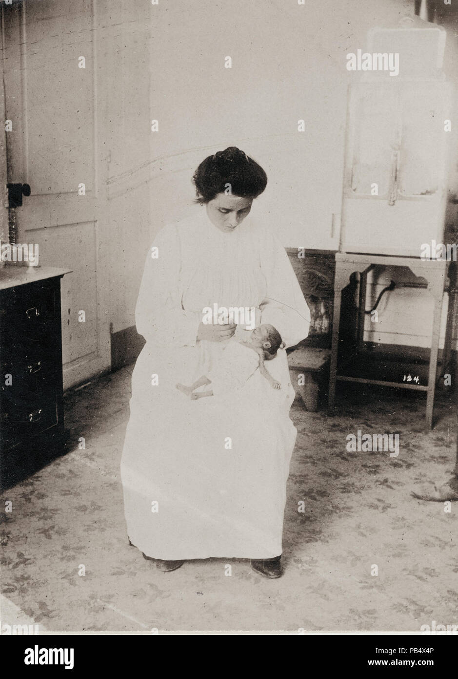 1122 Nurse feeding a premature baby in the Baby Incubator exhibit on the Pike at the 1904 World's Fair. ( Stock Photo