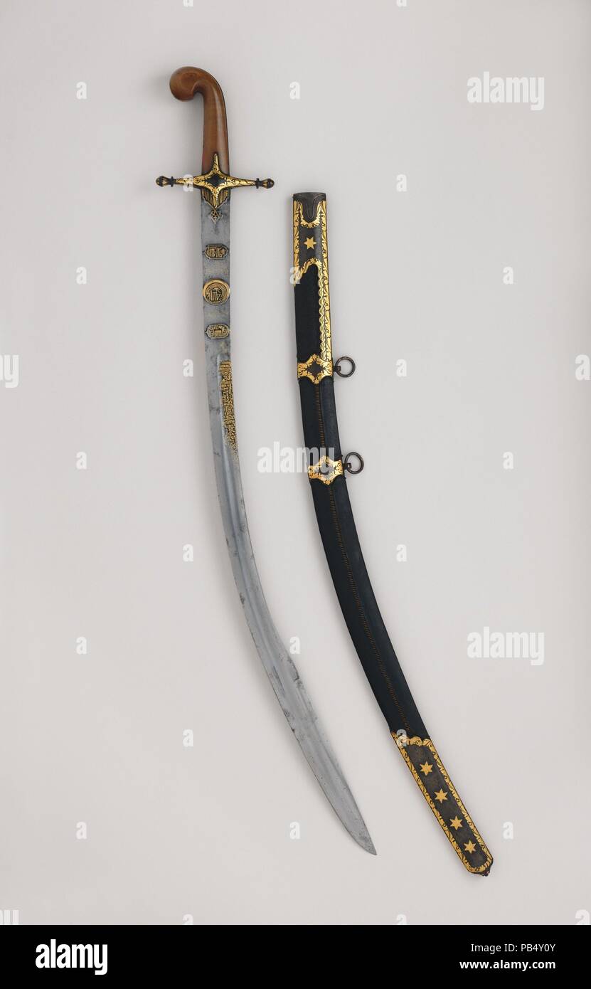 Saber (Kilij) with Scabbard. Culture: Hilt, Turkish or North African; blade, Iranian. Dimensions: H. with scabbard 36 1/2 in. (92.7 cm); H. without scabbard 35 1/2 in. (90.2 cm); H. of blade 30 3/4 in. (78.2 cm); W. 5 1/4 in. (13.3 cm); Wt. 1 lb. 8.3 oz. (688.9 g); Wt. of scabbard 14 oz. (396.9 g). Date: hilt and scabbard, 19th century; blade, probably late 18th-early 19th century.  This type of Ottoman saber, with its distinctive curled 'pistol grip' and cruciform guard, was used throughout Turkey and North Africa from the eighteenth century. Following Napoleon's invasion of Egypt in 1798, th Stock Photo