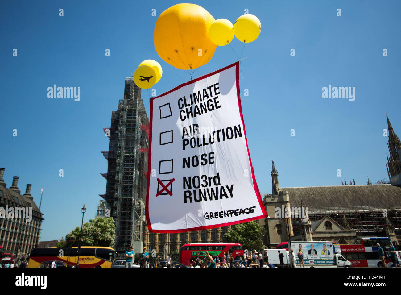 Greenpeace publicity stunt on Parliament Square. Five yellow balloons hold aloft a banner indicating a no vote, ahead of the vote in the Commons for a third runway at London's Heathrow.  Featuring: Atmosphere, View Where: London, England, United Kingdom When: 25 Jun 2018 Credit: Wheatley/WENN Stock Photo