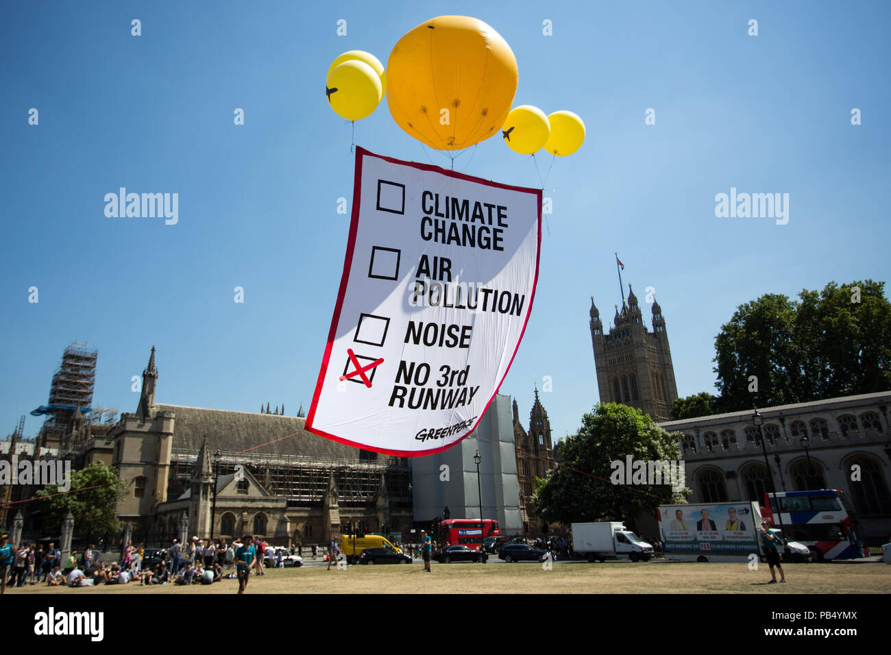 Greenpeace publicity stunt on Parliament Square. Five yellow balloons hold aloft a banner indicating a no vote, ahead of the vote in the Commons for a third runway at London's Heathrow.  Featuring: Atmosphere, View Where: London, England, United Kingdom When: 25 Jun 2018 Credit: Wheatley/WENN Stock Photo