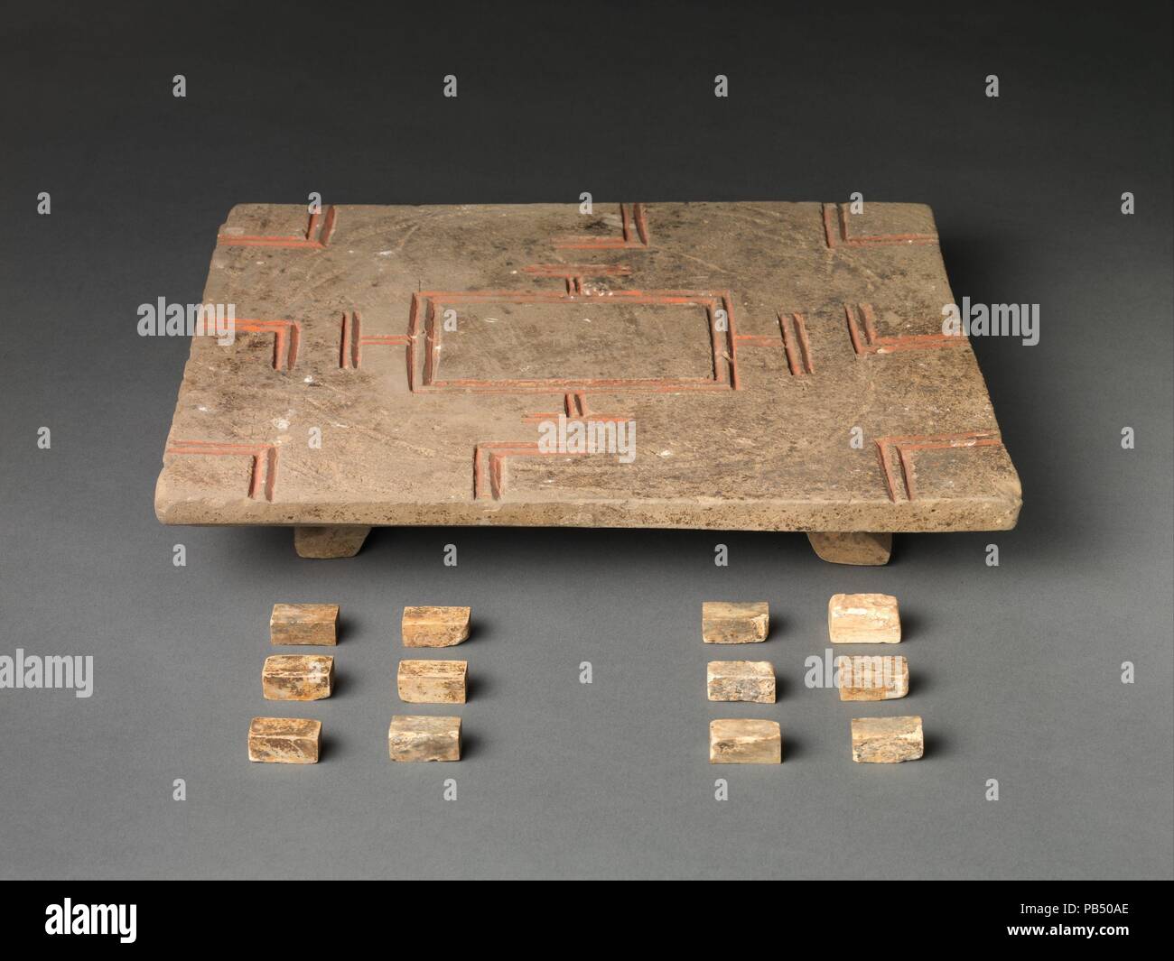Liubo Board and Pieces. Culture: China. Dimensions: L. 14 1/4 in. (36.2 cm); W. 12 3/8 in. (31.4 cm); H. 2 in. (5.1 cm). Date: 1st century B.C.-1st century A.D..  A popular game in the Han dynasty, liubo involves two players who gamble using dice, counters, gaming pieces, and a marked board. These figures, captured in a dramatic moment, embody the wish for the continuation of life in the tomb. Museum: Metropolitan Museum of Art, New York, USA. Stock Photo