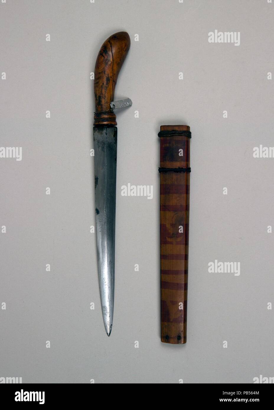 Dagger with Sheath. Culture: Philippine, Mindanao. Dimensions: L. with sheath 11 1/8 in. (28.3 cm); L. without sheath 11 in. (27.9 cm); L. of blade 7 1/2 in. (19.1 cm); W. 1 in. (2.5 cm); Wt. 3.4 oz. (96.4 g); Wt. of sheath 1.4 oz. (39.7 g). Date: 18th-19th century. Museum: Metropolitan Museum of Art, New York, USA. Stock Photo