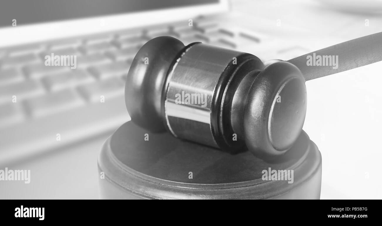 Gavel and laptop on desk Stock Photo