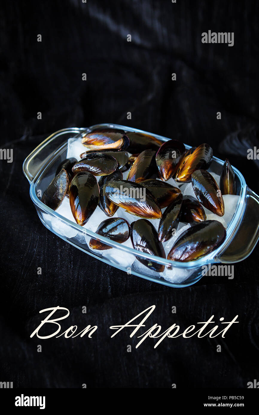 Very tasty and fresh mussels on ice cubesthe inscription of a Bon