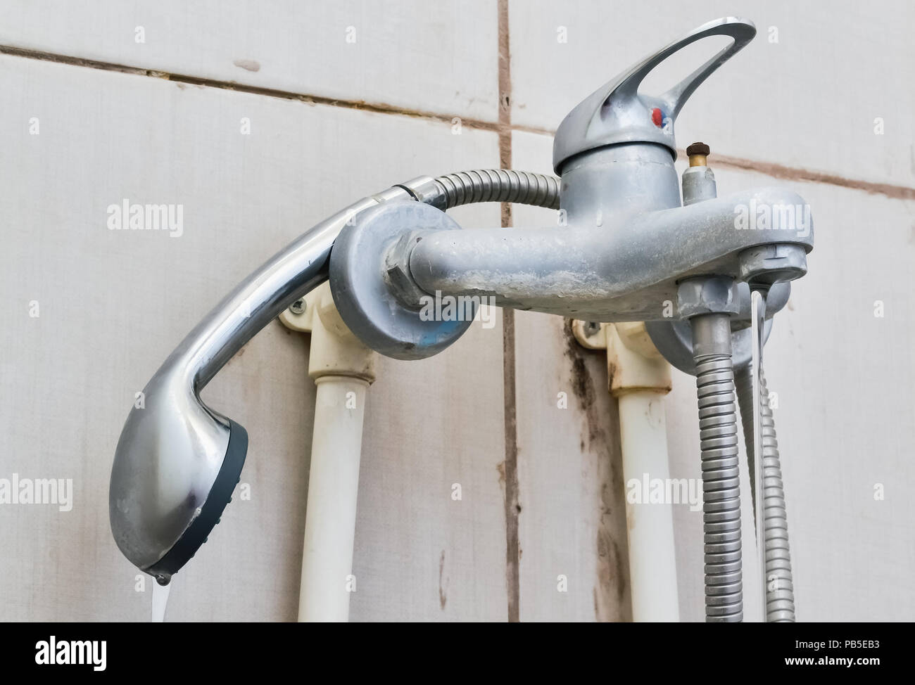 Old Water Pipes And Broken Faucet In The Bathroom Stock Photo