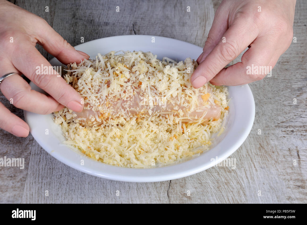 Cooking. Breaded stuffed chicken roll in a mixture of crumb breadcrumbs with grated parmesan