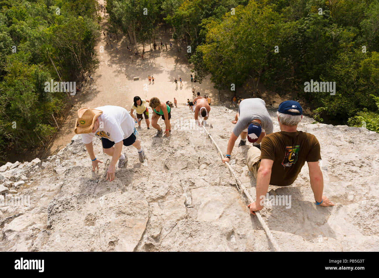 Tourists climb the Great Pyramid Nohoch Mul at the Coba archeological site in Quintana Roo state in Southern Mexico. Stock Photo