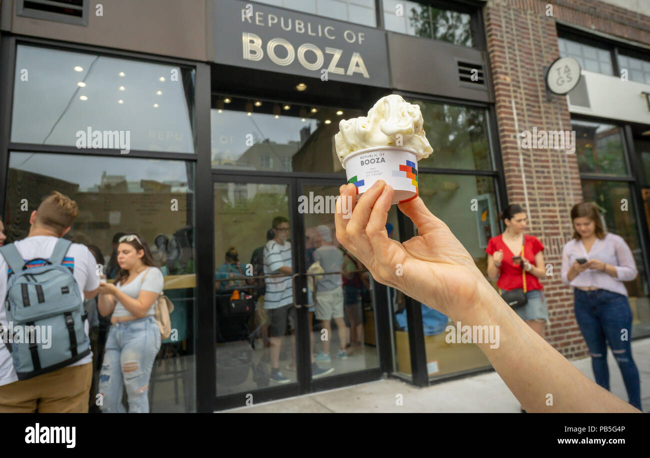 An ice cream lover holds up her cup of booza ice cream, from the ice cream parlor, Republic of Booza, in the Williamsburg neighborhood of Brooklyn on Sunday, July 22, 2018. Booza is a Middle Eastern treat, served warmer than ice cream, and stretched and paddled to achieve tis taffy-like consistency. (Â© Richard B. Levine) Stock Photo