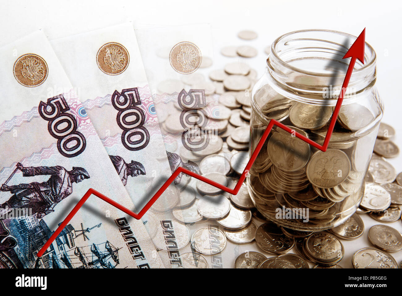 business still life of money bills and coins with a bank and a graph of ...