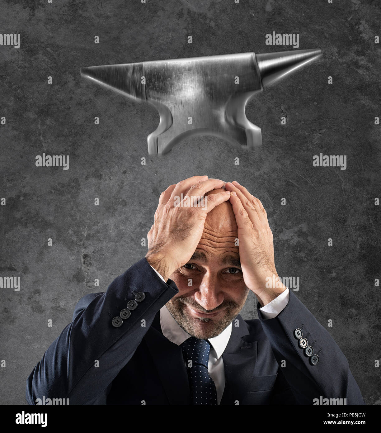 Difficult career in business with falling anvil Stock Photo