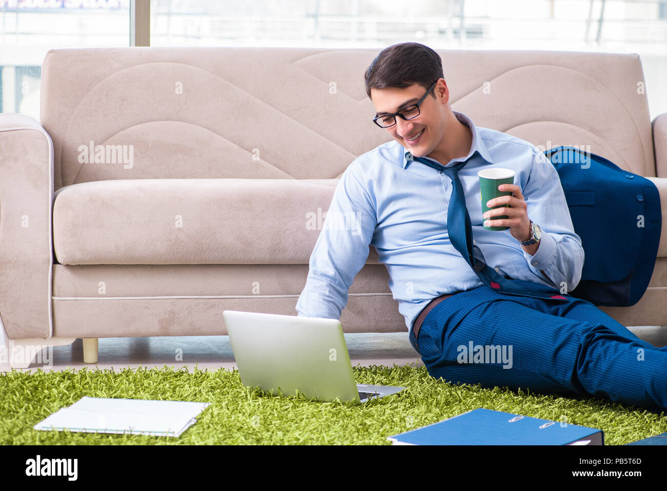 Businessman taking work home and working overtime Stock Photo