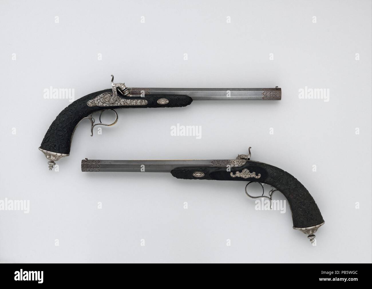 Cased Pair of Percussion Pistols with Accessories. Culture: French, Paris. Dimensions: Pistols (a, b); L. of each 16 in. (40.7 cm); L. of each barrel 10 5/8 in. (27 cm); Cal. of each .46 in. (12 mm); Wt. of each 2 lb. 3 oz. (992.2 g); ramrod (c); L. 11 1/4 in. (28.6 cm); Wt. 1.5 oz. (42.5 g); cleaning rod (d); L. 12 3/8 in. (31.4 cm); Wt. 1.8 oz. (51 g); mallet (e); L. 7 7/8 in. (20 cm); W. 2 1/2 in. (6.4 cm); Wt. 5.3 oz. (150.3 g); screwdriver (f); L. 6 1/4 in. (15.9 cm); Wt. 2.6 oz. (73.7 g); bullet mould (g); L. 7 7/8 in. (20 cm); Wt. 8.8 oz. (249.5 g); powder flask (h); H. 4 in. (10.2 cm); Stock Photo