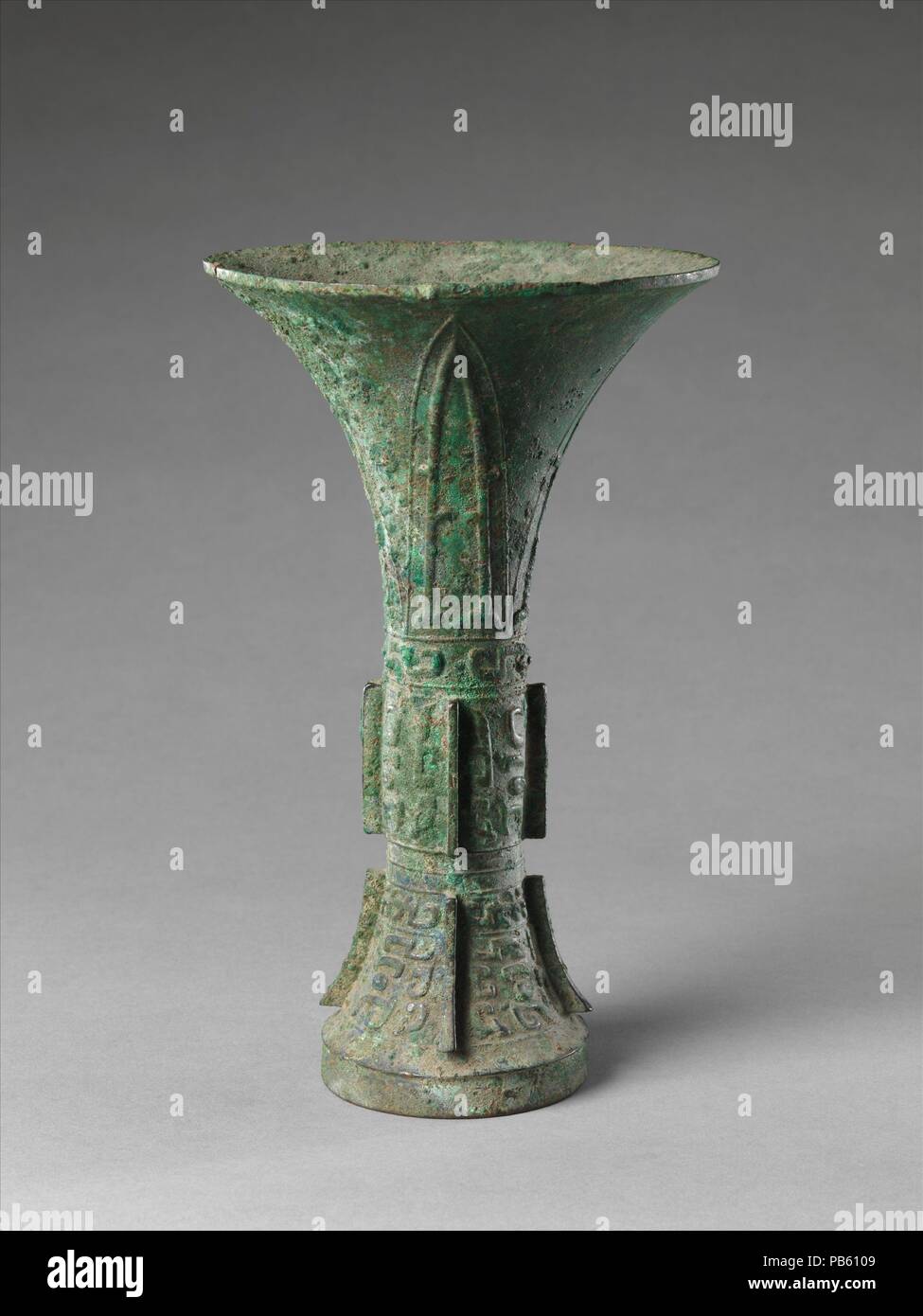 Ritual Wine Beaker (Gu). Culture: China. Dimensions: H. 8 1/4 in. (21 cm); Diam. of rim: 5 in. (12.7 cm); Diam. of foot: 2 13/16 in. (7.1 cm); Wt. 1 lb. (0.5 kg). Date: late 11th century B.C..  This elaborate set of wine vessels provides an idea of the splendor of Shang and early Zhou ritual ceremonies. The set is said to have come from a tomb uncovered in 1901; shortly thereafter, it entered the collection of Duan Fang, a senior Manchu official and one of the preeminent antiquarians of the late Qing period.   The pieces vary in style and execution. Although eleven of the vessels are inscribed Stock Photo