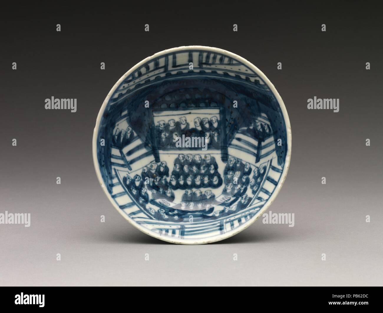 Bowl with Buddhist Assembly. Culture: China. Dimensions: H. 2 1/16 in. (5.2 cm); Diam. 6 in. (15.2 cm); Diam. of foot 2 3/8 in. (6 cm).  Made for use in Japan, either in a Buddhist context or as part of a meal during a Japanese tea ceremony, this charming bowl is painted with a rare scene of a Buddhist assembly. Museum: Metropolitan Museum of Art, New York, USA. Stock Photo