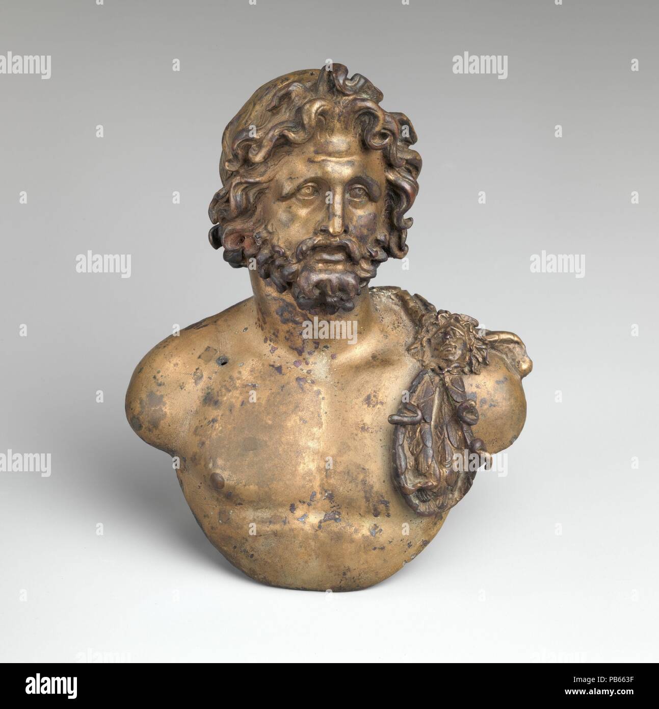 Bronze bust of Jupiter. Culture: Roman. Dimensions: H. 6 3/16 in. (15.7 cm). Date: late 1st century B.C.-1st century A.D..  The bust likely served as an emblema (centerpiece) of a bowl. Jupiter wears an aegis with gorgoneion over his left shoulder. The right nipple is inlaid with copper. Museum: Metropolitan Museum of Art, New York, USA. Stock Photo