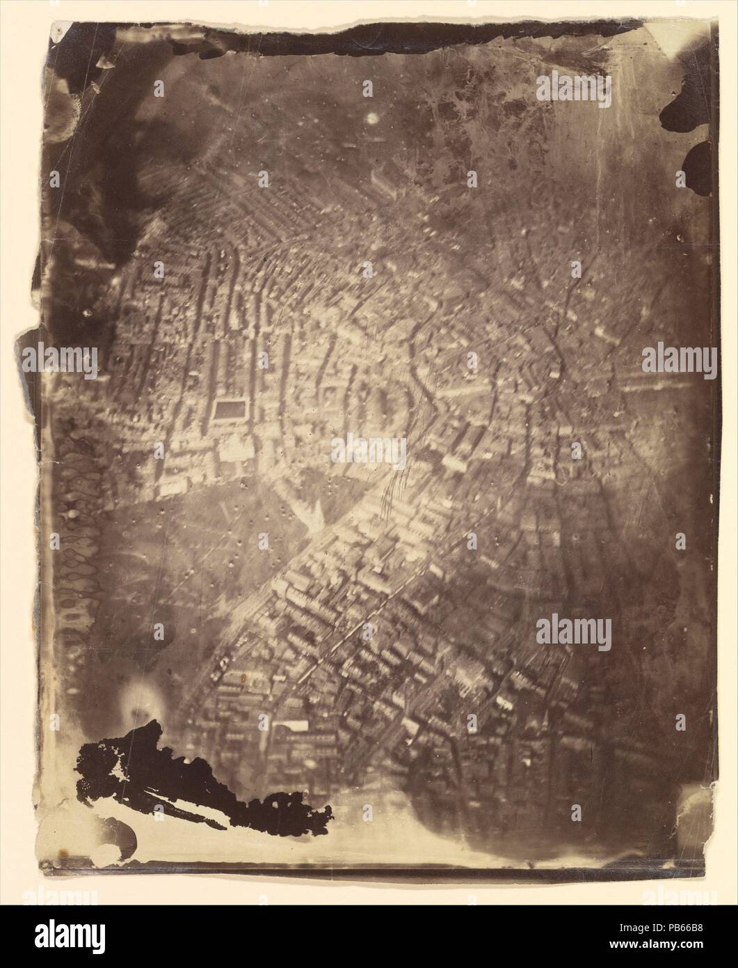 [Boston from a Hot-Air Balloon]. Artist: James Wallace Black (American, 1825-1896). Dimensions: 25.6 x 20.2 cm. (10  1/16  x 7  15/16  in.). Date: 1860s.  Two years after the French photographer Nadar conducted his earliest experiments in balloon flight, the Boston photographer James Wallace Black ascended over the city to make the first successful aerial photographs in America. He flew on Samuel King's hot-air balloon, the 'Queen of the Air,' and exposed several glass-plate negatives, including this extraordinary, if imperfect, view-as much lunar landscape as 'Beantown.' Almost immediately, a Stock Photo