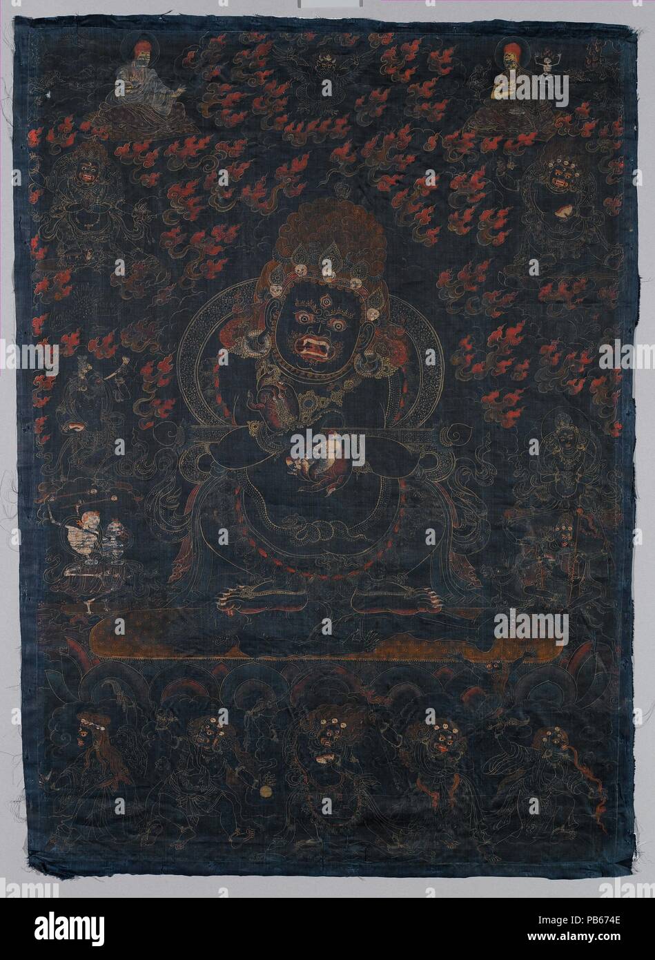 Mahakala, Protector of the Tent. Culture: Tibet. Dimensions: Image: 29 x 20 1/2 in. (73.7 x 52.1 cm)  Overall: 30 1/4 x 21 3/4 in. (76.8 x 55.2 cm). Date: ca. 1650.  This black-ground painting is a visualization image of Mahakala as Panjarantha, the enlightened protector of Buddhism. He tramples a male corpse beneath his feet and displays a flaying knife (kartrika) in his right hand and a skull cup (kapala) in his left, implements for cutting through delusions and ignorance. A ritual wand (gandi) is balanced in the crooks of his arms. Panjaranatha is understood as the 'original' Mahakala from  Stock Photo