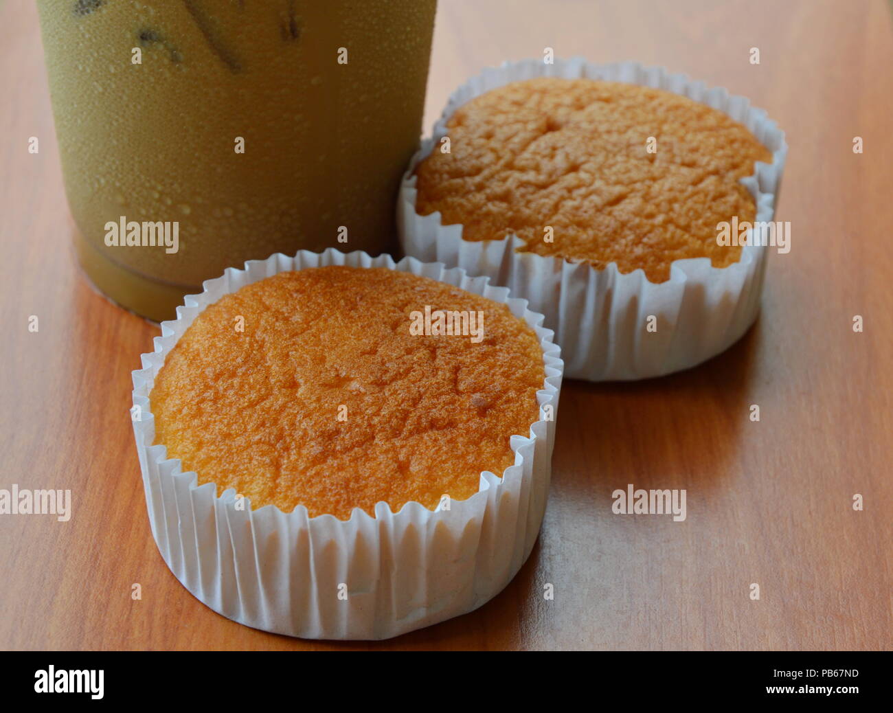 butter cupcake and ice coffee on table Stock Photo
