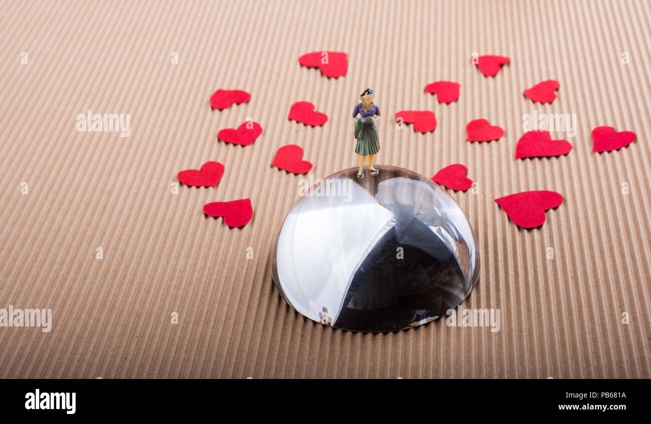 Woman figurine and Love concept with red paper hearts Stock Photo - Alamy