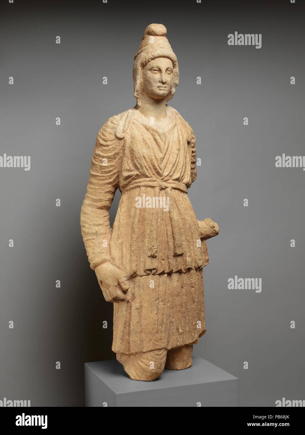 Limestone statue of Artemis Bendis. Culture: Cypriot. Dimensions: 30 3/4 x 12 3/4 x 7 1/4 in.  (78.1 x 32.4 x 18.4 cm). Date: ca. 3rd century B.C..  The head and the body come from different statues. Bendis was a goddess of the hunt, similar to Artemis. Her worship originated in Thrace, a rugged mountainous region in what is today Bulgaria, but became fairly widespread throughout the Greek world by the Hellenistic period. She wears Oriental dress, with a soft leather Phrygian cap and a long-sleeved tunic and trousers. Museum: Metropolitan Museum of Art, New York, USA. Stock Photo