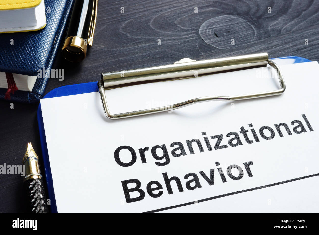 Organizational Behavior report on an office desk. Stock Photo