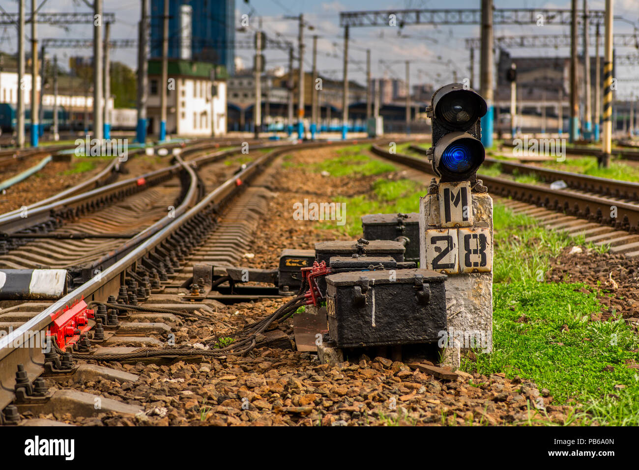 blue signal of the semaphore on the background of the railway track Stock Photo