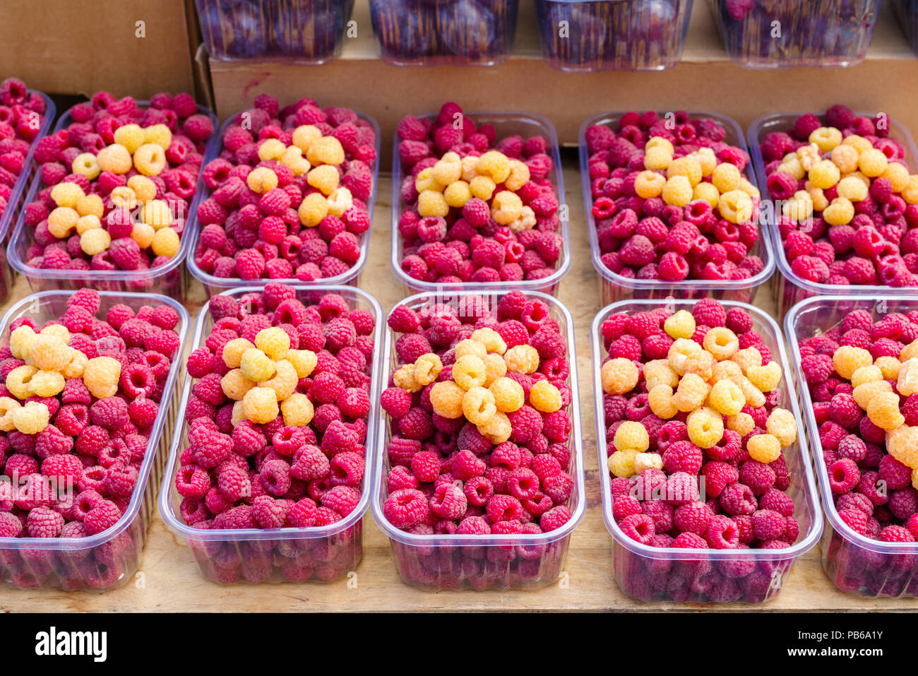 Fresh raspberries in blue containers hi-res stock photography and ...