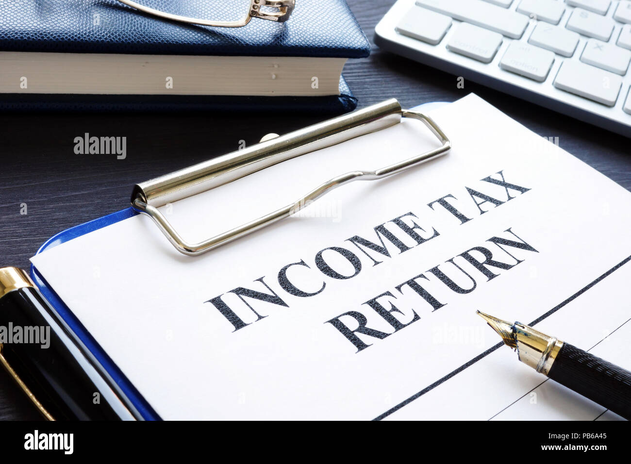 Income tax return documents and pen on a desk stock photo alamy